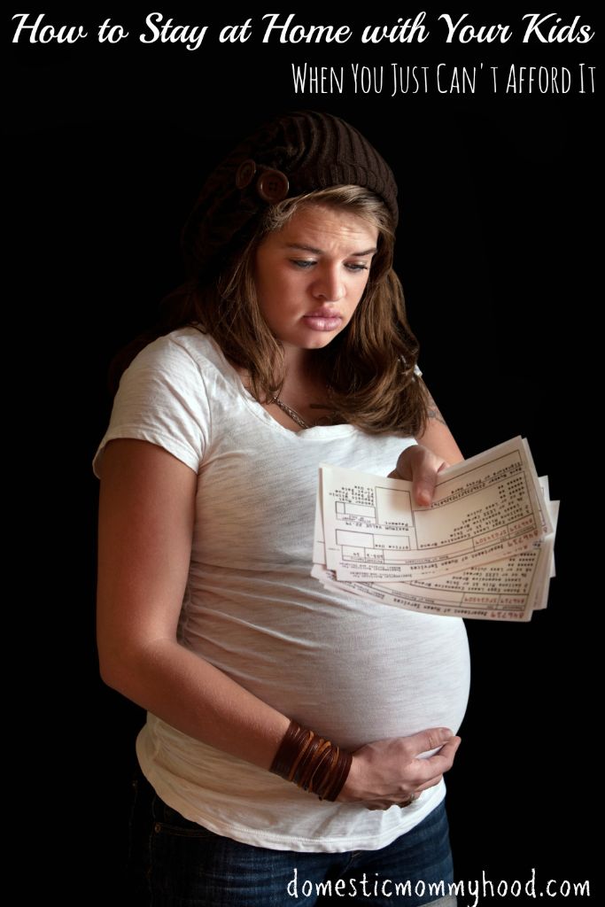 Sad pregnant woman with food coupons over black background