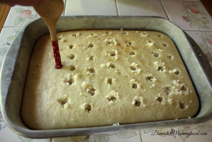 strawberry poke cake poking holes